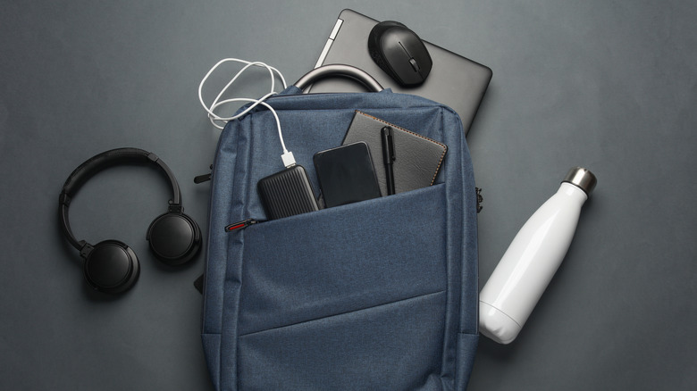 A laptop bag containing various gadgets and accessories.