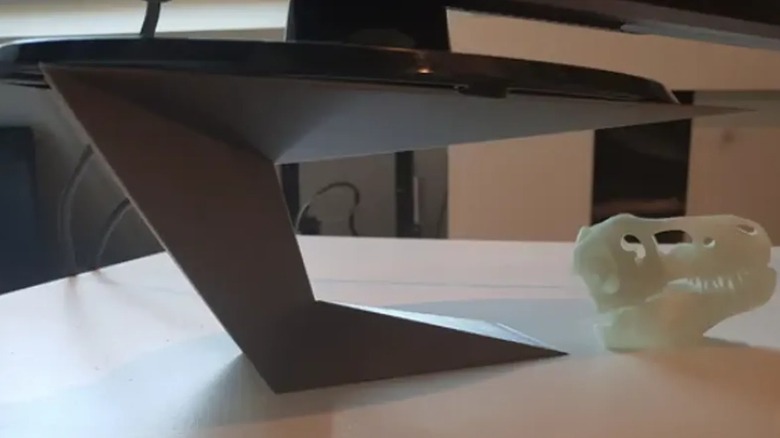 A 3D printed stand propping up a monitor.