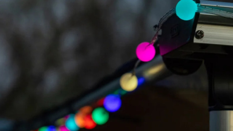 A promotional image showing three packs of the Enbrighten Color Changing Light Bulbs, highlighting both the box, the lights, and their controllers