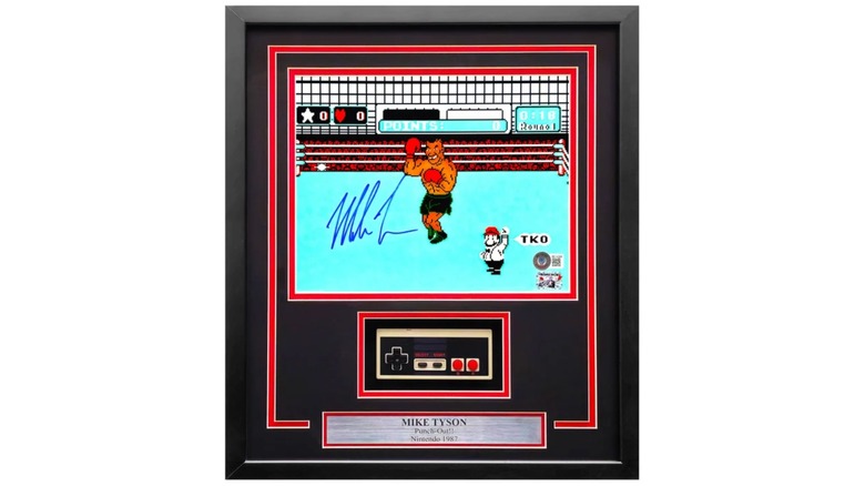 A promotional image for an autographed Mike Tyson from a screenshot of the game "Punch-Out!!," the framed collection also features an NES controller along with a small plaque
