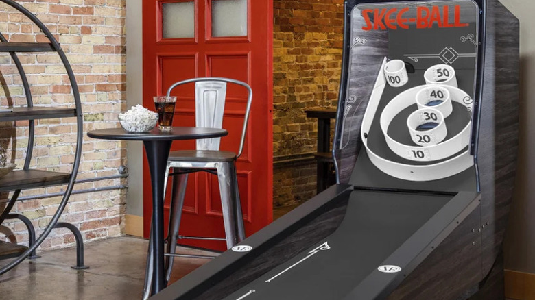 A promotional photo for the Skee-Ball 9-foot Signature Steel Home Arcade Game, the image depicts a black Skee-Ball machine displaying a high score