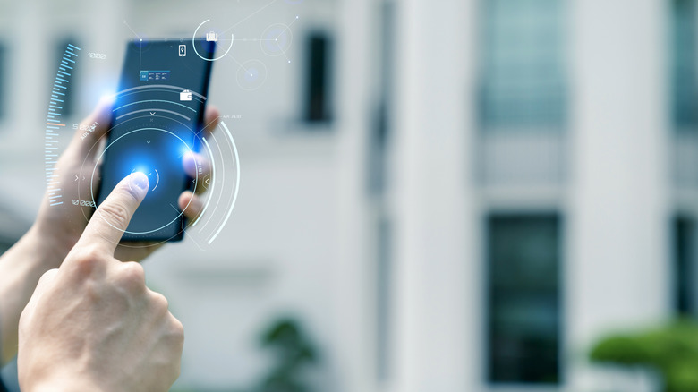 A person controlling their smart garage with a smartphone app