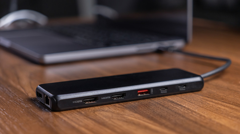 usb hub connected to a laptop and placed on a wooden table