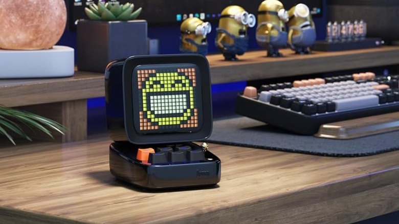 A Divoom Ditoo speaker on a desk.