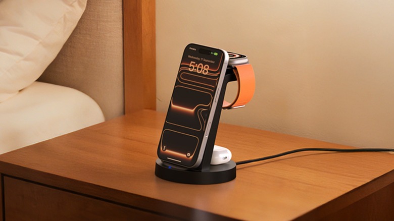 The Anlmz 3-in-1 Wireless Charging Station sitting on a nightstand, the device is charging an iPhone, Apple Watch, and AirPods