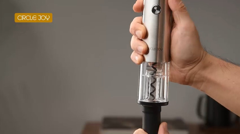 Hand using Circle Joy Rechargeable Electric Wine Opener on a wine bottle