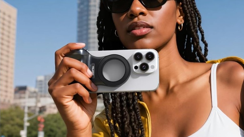 A woman using the TELESIN Magnetic Phone Camera Grip on an iPhone.