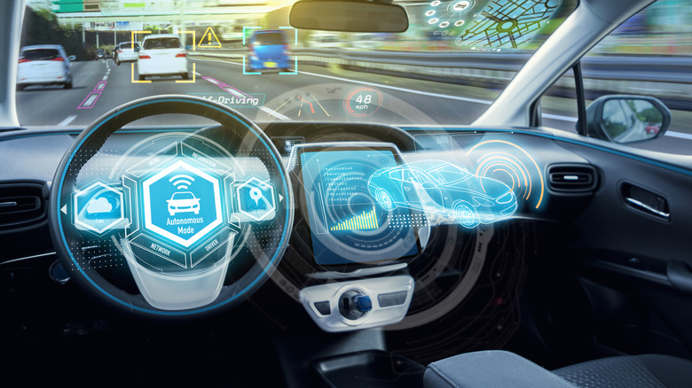 The interior of a vehicle with graphics depicting autonomous driving modes