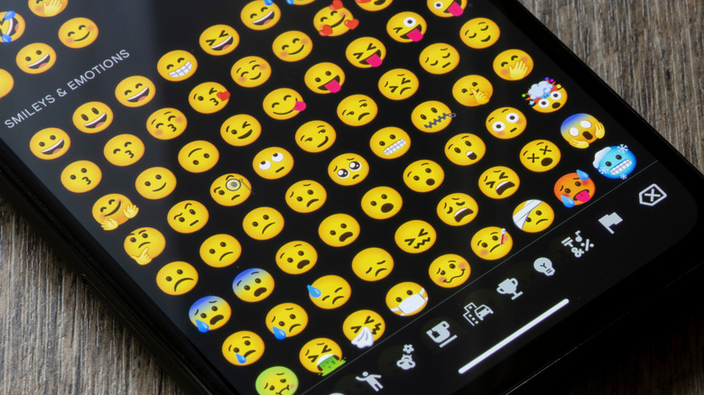 android smartphone showing a variety of emoji on the display