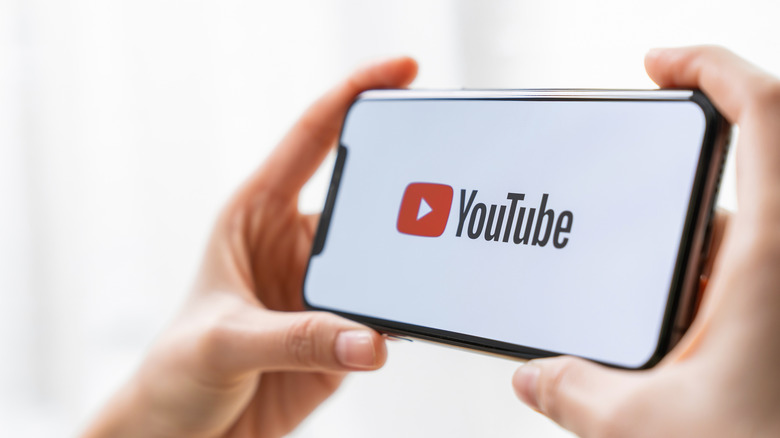 close-up of phone with white screen and YouTube logo