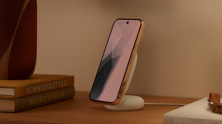 Close-up of the Pixel 11 Pro in new orange color on the Pixelsnap charger
