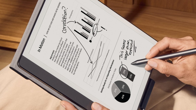 Person marking up report with notes on Amazon Kindle Scribe