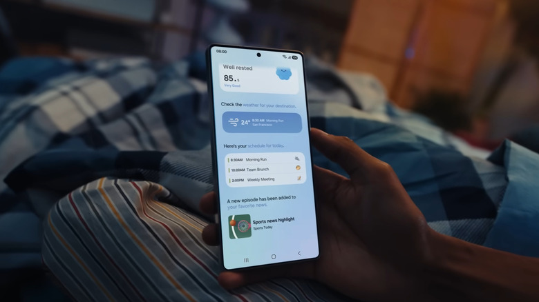 Hand holding Samsung phone showing weather and schedule