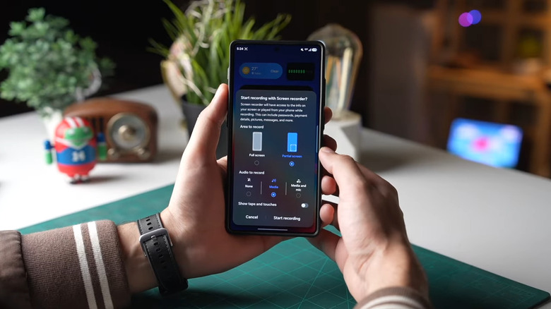 Hand holding Galaxy phone showing screen recorder options