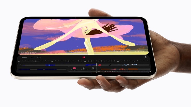 A hand holding an iPad mini