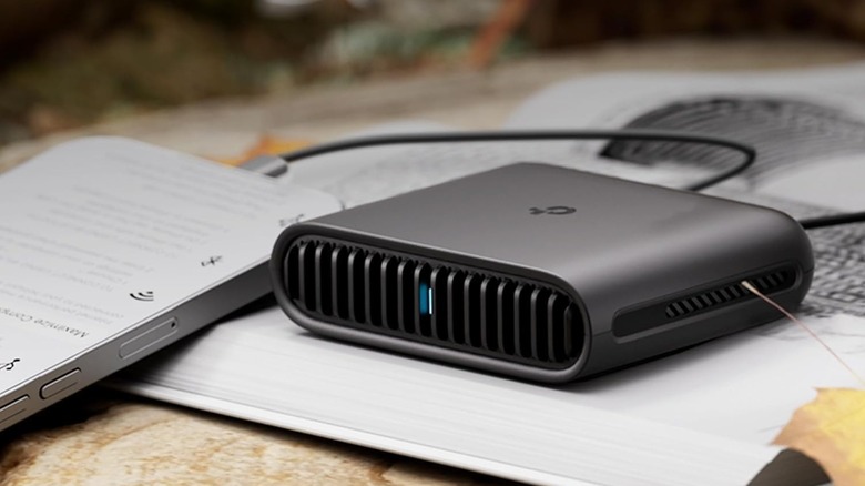 A TP-Link router on a book outdoors.