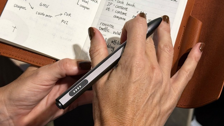 Close-up shot at woman's hand with a smart pen in hand