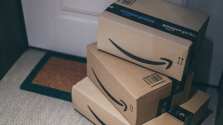 multiple Amazon boxes in front of a door