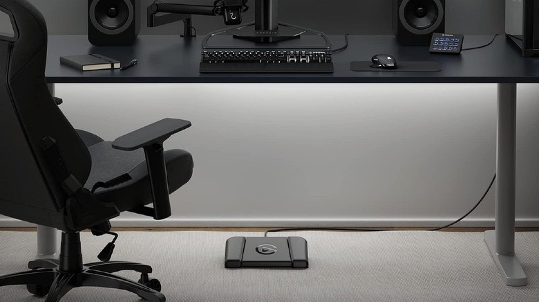 Elgato Stream Deck foot pedal plugged in below a desk.