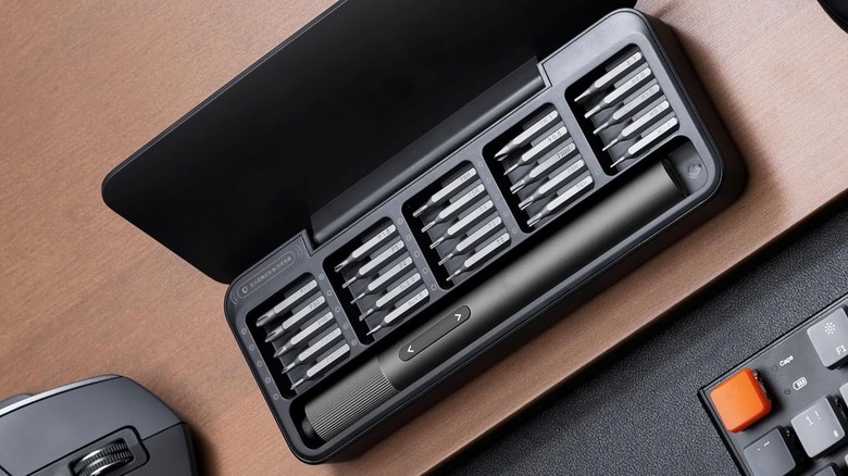 HOTO mini electric screwdriver, pictured in its case with bits.