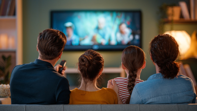 A family spending time together on the couch watching TV