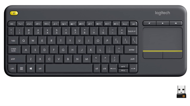 The Logitech k400 plus keyboard and USB receiver on a white background