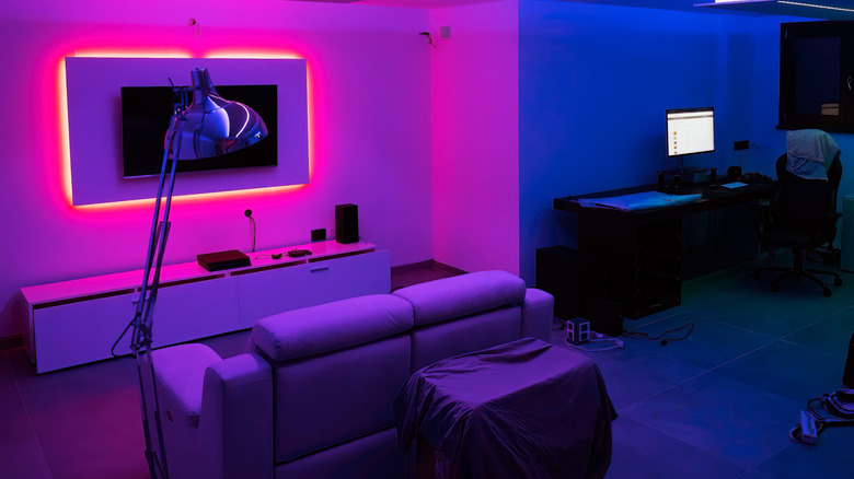 A dark living room decorated with purple LED lights
