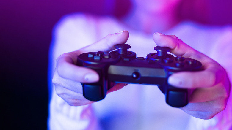 A woman holding a game controller