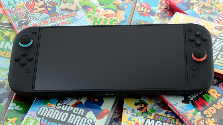 Nintendo Switch 2 console placed on top of colorful physical game cases.