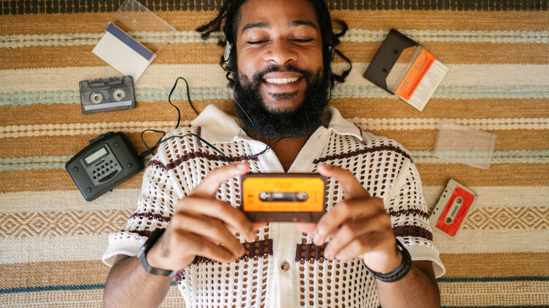 Man listening to cassette tape player