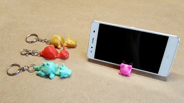 3D printed smartphone stand keychains on a table