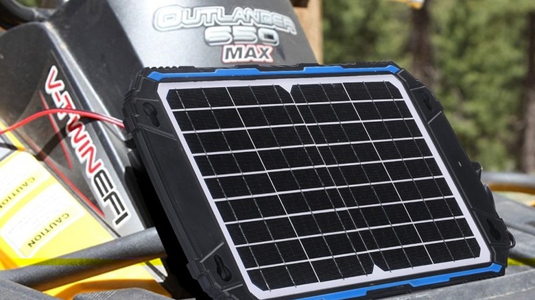Suner Power Waterproof Solar Battery Charger strapped to an ATV