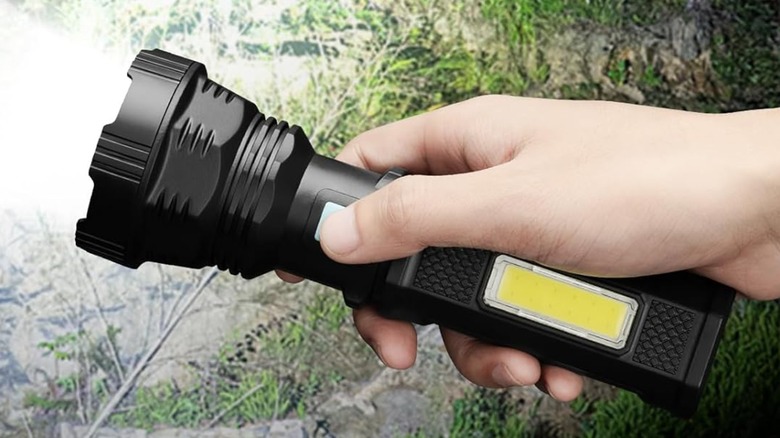 A person holding a Voetir LED Solar Flashlight.