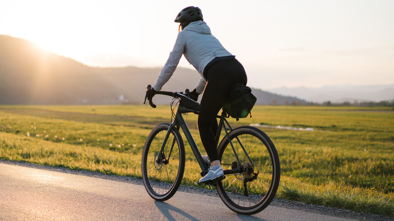 A person riding a bike on a road