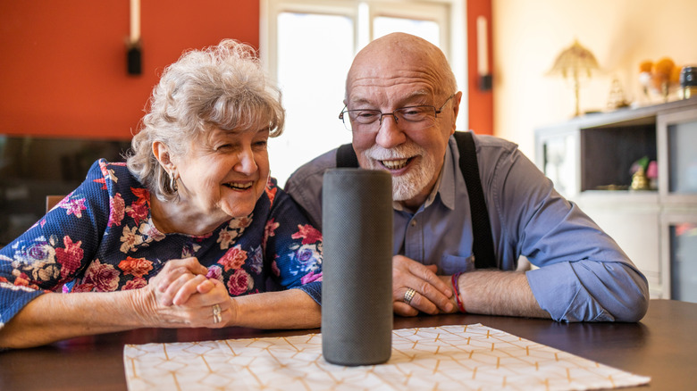 Elderly couple using a smart speaker.