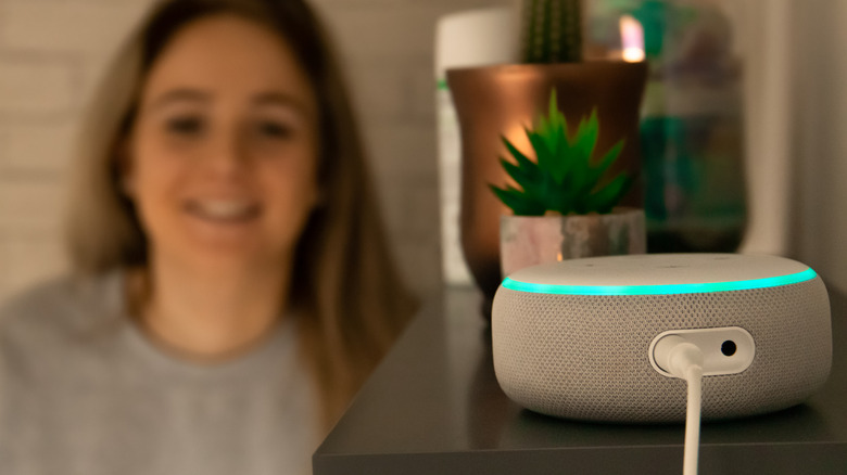 Amazon Echo in the foreground with younger user in the background.