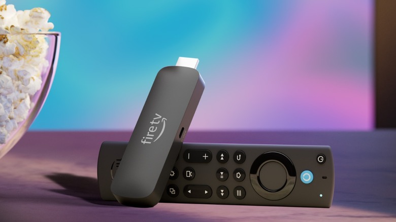 Amazon Fire TV Stick with remote next to popcorn