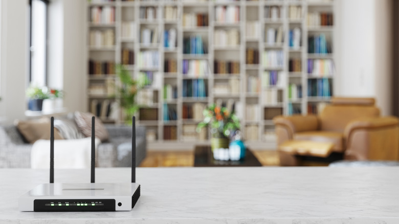 Wi-Fi router on a counter with living room in the background.