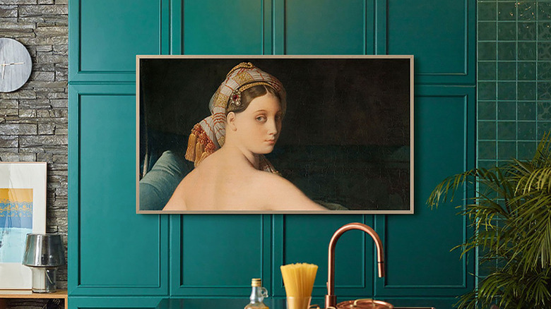 A Samsung The Frame TV showing artwork while hanging on the wall