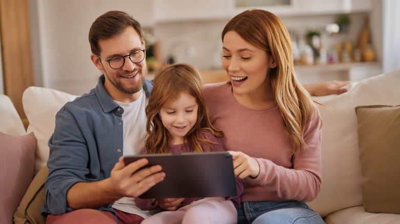 A family sharing a tablet