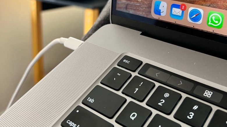 Close-up of a MacBook Pro charging with a USB-C cable