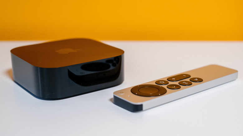 Apple TV streaming box with remote control on a table