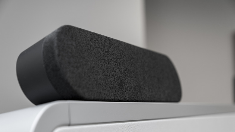 Black fabric soundbar speaker close-up on clean indoor background