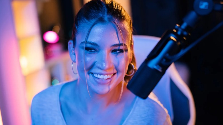A woman recording a podcast with a Sennheiser microphone