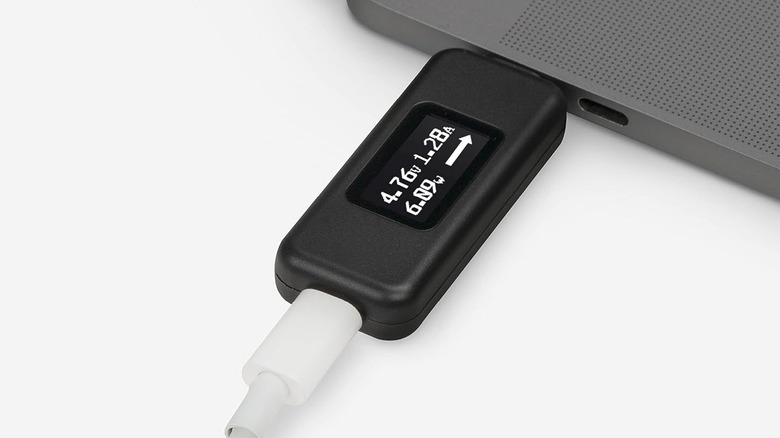 The Plugable USB-C Power Tester connected to a laptop, with a USB-C cable plugged into the other end.