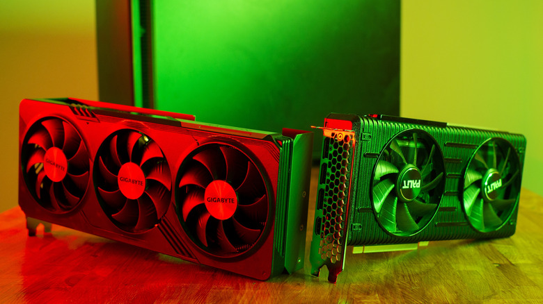 A photograph of two graphics cards sitting side by side on a table.