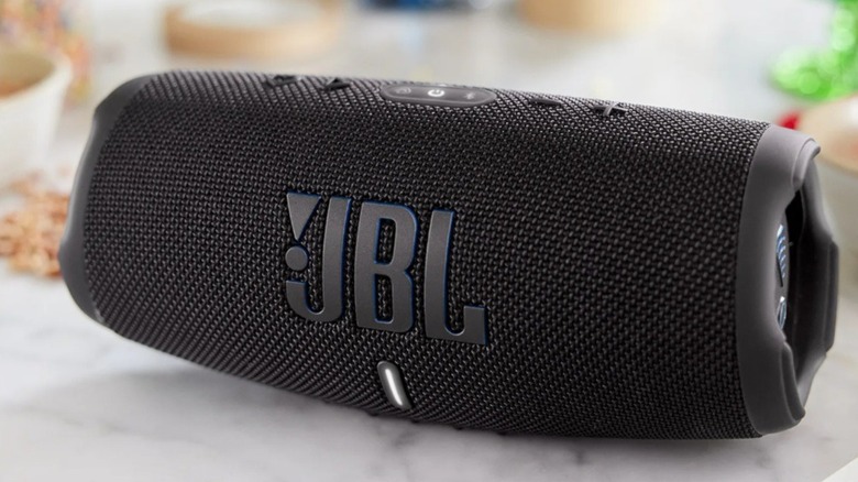 The JBL Charge 5 Wi-Fi SE Portable Waterproof Speaker on a marble countertop.