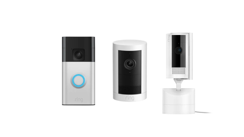 A product line of Ring's popular doorbell, outdoor camera, and indoor camera stand side-by-side before a white background.