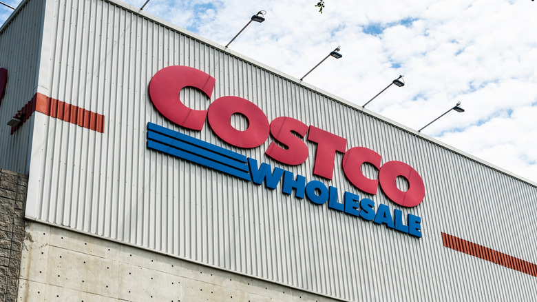 A Costco warehouse with the red and blue Costco sign on the building