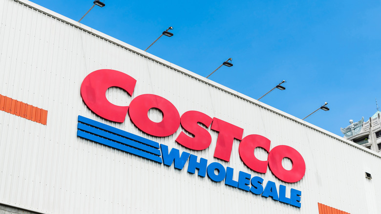 The Costco Wholesale logo on a retail building.